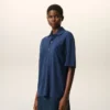 Ami de Coeur Polo en coton bleu avec écusson en tricot