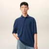 Ami de Coeur Polo en coton bleu avec écusson en tricot
