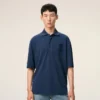 Ami de Coeur Polo en coton bleu avec écusson en tricot