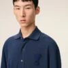 Ami de Coeur Polo en coton bleu avec écusson en tricot