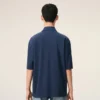 Ami de Coeur Polo en coton bleu avec écusson en tricot