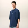Ami de Coeur Polo en coton bleu avec écusson en tricot