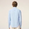 Chemise ajustée à manches longues en coton bleu à volants