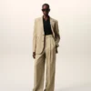 Pantalon beige en laine vierge à taille haute et jambes larges