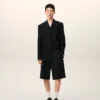 Veste droite en laine vierge noire à simple boutonnage